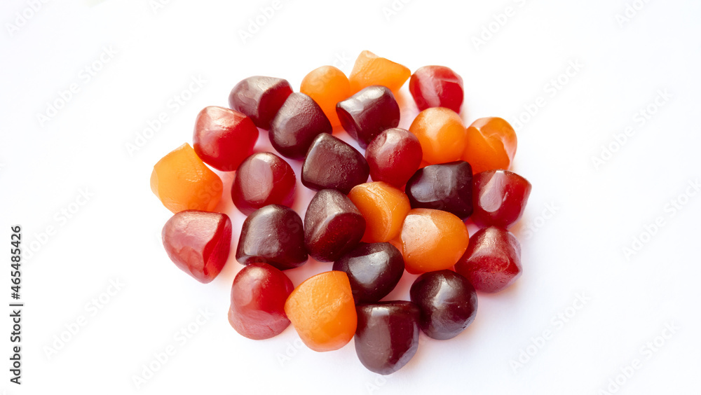 Close-up texture of red, orange and purple multivitamin gummies on white background. Healthy lifestyle concept Close-up texture of red, orange and purple multivitamin gummies on white background. Healthy lifestyle concept