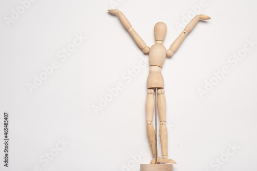 wooden man mannequin posing object light background