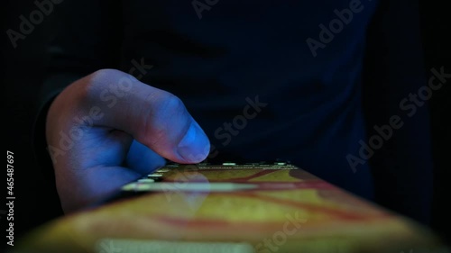 Young Man Look in Mobile Phone and Browse Social Network Close up. Relaxed Adult Male Read App Cellphone at Night. 30s Hipster Online Touch Fingers of Cell Phone Chatting Indoors. Life in Mobilephone