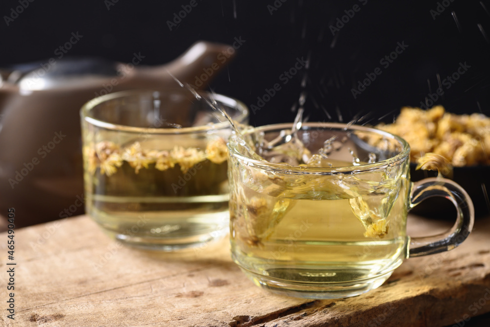 Chrysanthemum flower hot tea in a cup glass and teapot with dry flowers, Healthy Herbal drink Chrysanthemum flower hot tea in a cup glass and teapot with dry flowers, Healthy Herbal drink