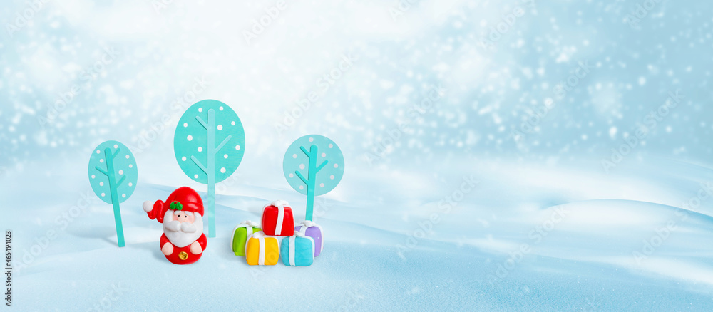 Santa Claus with gifts. Small Christmas decorations for sweets. Free space for greeting card text