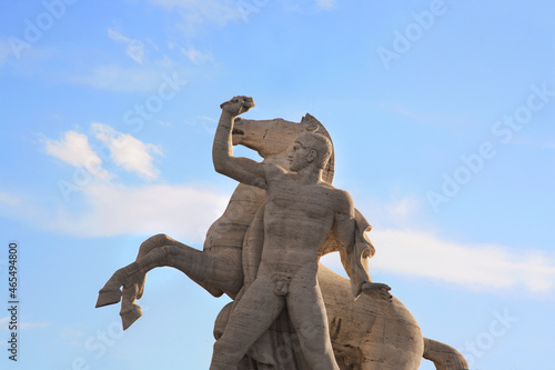 Man and horse statue in front Palazzo della Civilta Italiana, Square Colosseum. The monument lies in the EUR district. photo