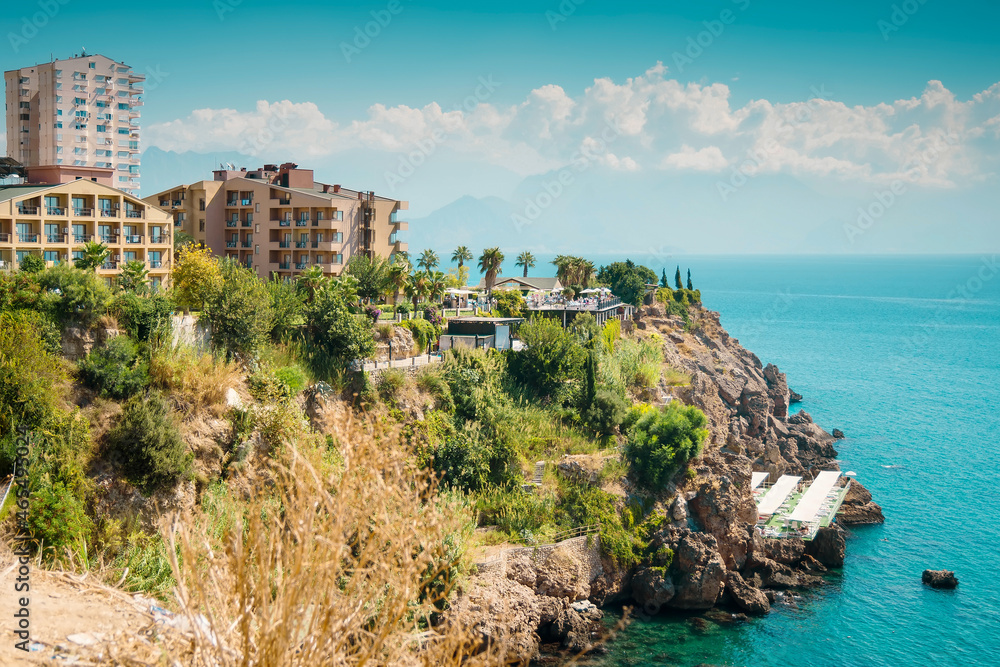 View of a modern multi storey resort hotel at Mediterranean sea coast at Antalya historical downtown. Turkey resort