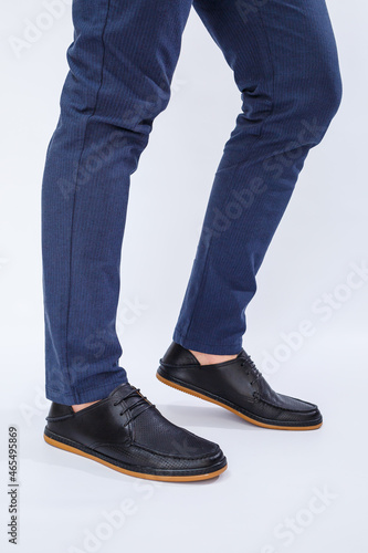 A man is wearing classic black shoes made of natural leather on lace, shoes for men under business style