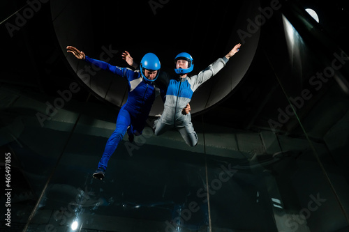 A man and a woman enjoy flying together in a wind tunnel. Free fall simulator