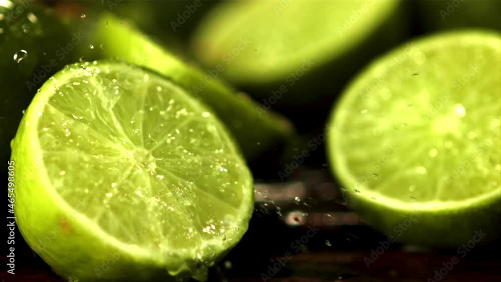 Super slow motion on half the juicy lime dripping water. Against a dark background.Filmed at 1000 fps. Super slow motion on half the juicy lime dripping water. Against a dark background.Filmed at 1000 fps.