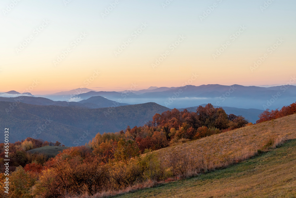 A sunrise over the mountains and forests