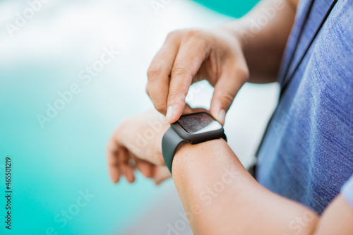 close up of a man s hand holding and setting a watch