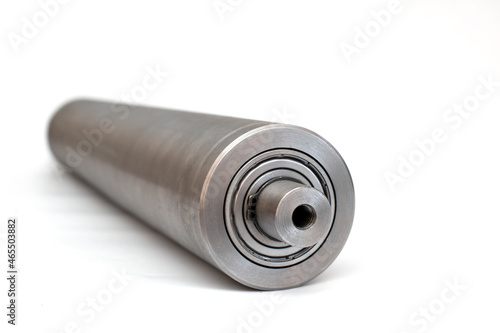 Steel metal pipe-shaft made on a lathe for the factory conveyor industry.