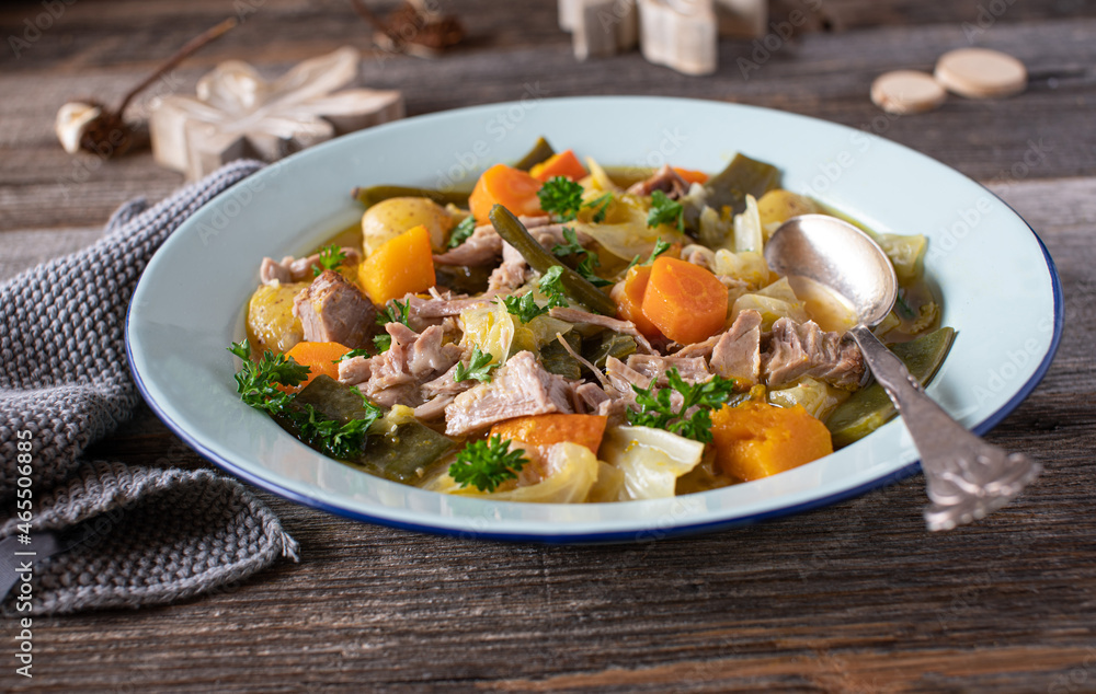 Plate with meat stew, potatoes, vegetables and cabbage