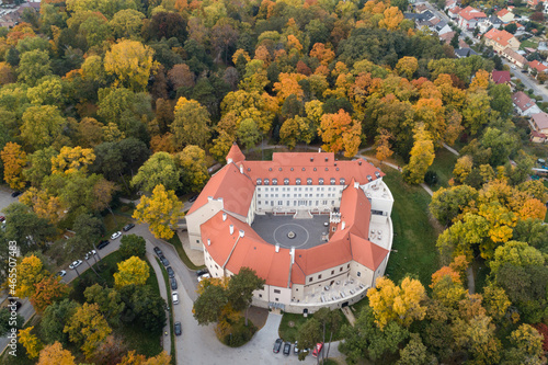 Aerial view of historial Castle surrounded by English park with rare trees in autumn colors, Pezinok, Slovakia