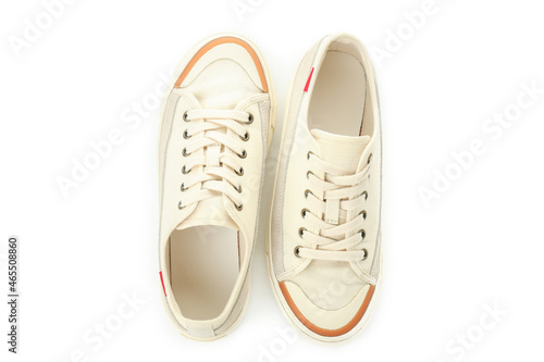 Pair of beige sneakers isolated on white background