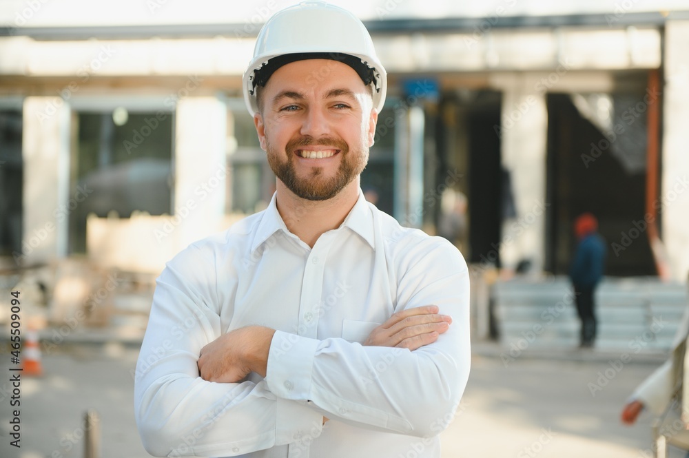 A construction worker control in the construction of roof structures on construction site and sunset background A construction worker control in the construction of roof structures on construction site and sunset background