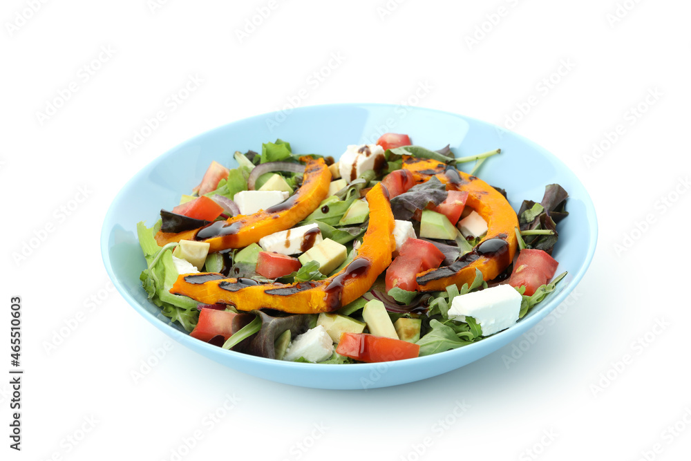 Plate with pumpkin salad isolated on white background
