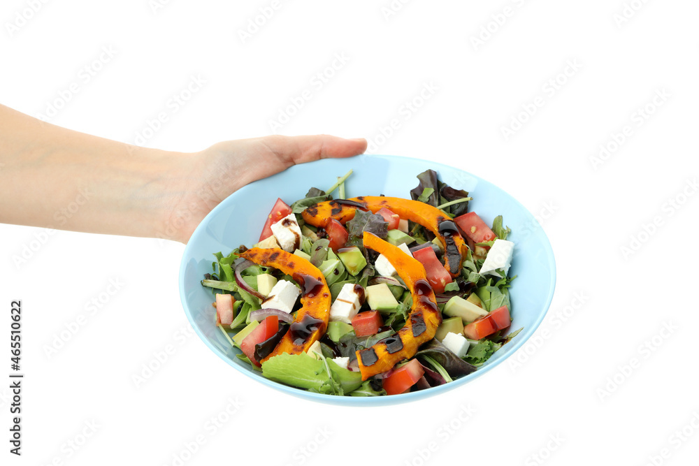 Woman's hand holding a plate of pumpkin salad, isolated on a white background Woman's hand holding a plate of pumpkin salad, isolated on a white background