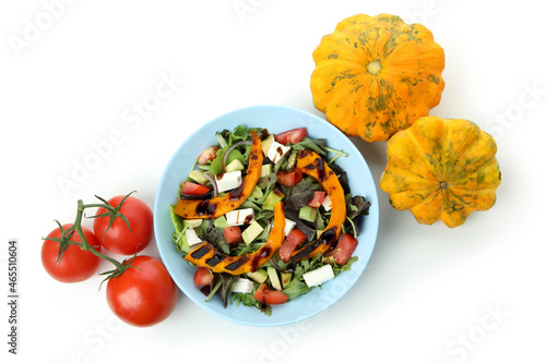 Plate with pumpkin salad and ingredients isolated on white background photo