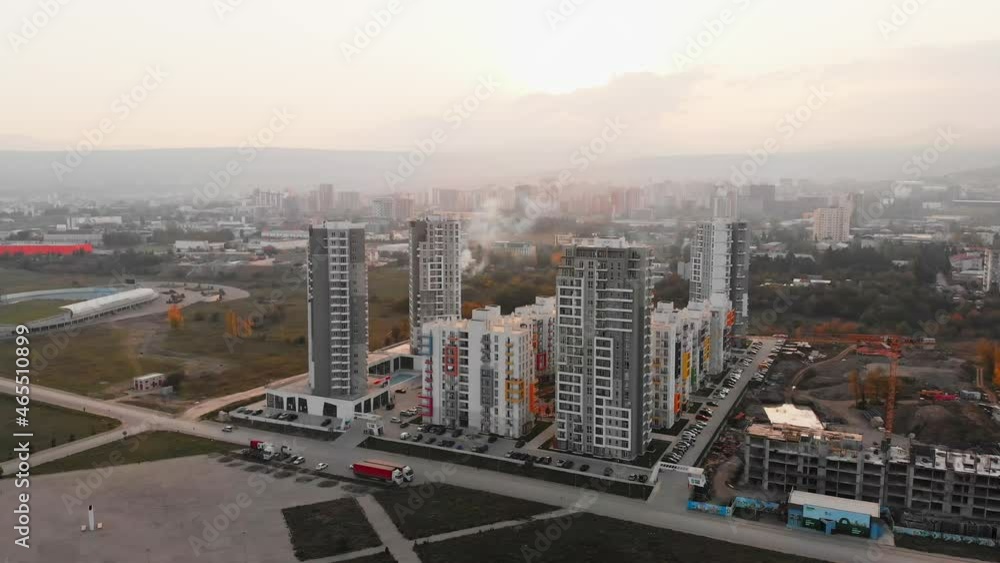 Real estate block buildings panorama with sun covered over horizon with hazy sky background Real estate block buildings panorama with sun covered over horizon with hazy sky background