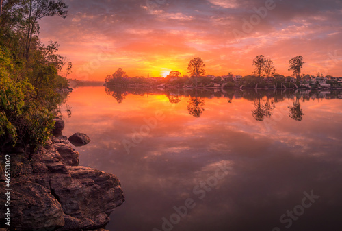 Beautiful Riverside Sunrise with Cloud Reflections