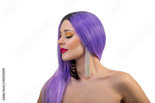 Portrait of beautiful young girl with fancy bright make-up and violet wig, on white background