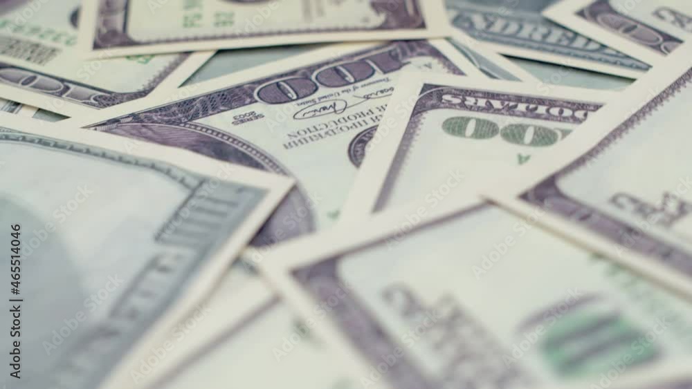 Hundred dollar bills spinning on a table, top view. Rotation paper money closeup. Background with money american hundred dollar bills. Concept of finance Hundred dollar bills spinning on a table, top view. Rotation paper money closeup. Background with money american hundred dollar bills. Concept of finance