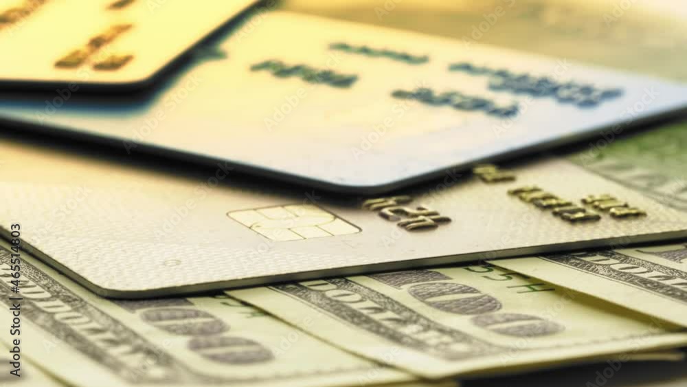 Dollar bill banknotes with plastic credit cards rotating on the table