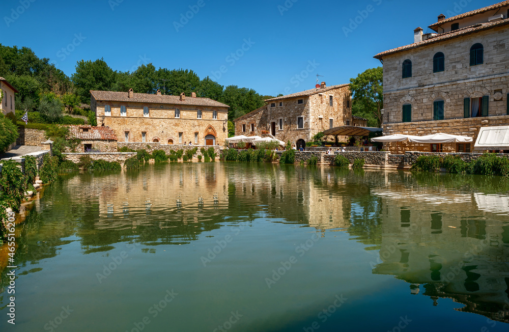 Bagno Vignoni, Tuscany, Italy. August 2020. A large natural outdoor thermal hot water pool is point of interest for tourists.
