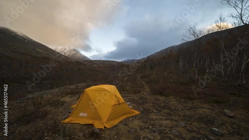 Yellow Tent and Clouds in Khibiny Mountains in Autumn Morning. Russia. Time Lapse photo