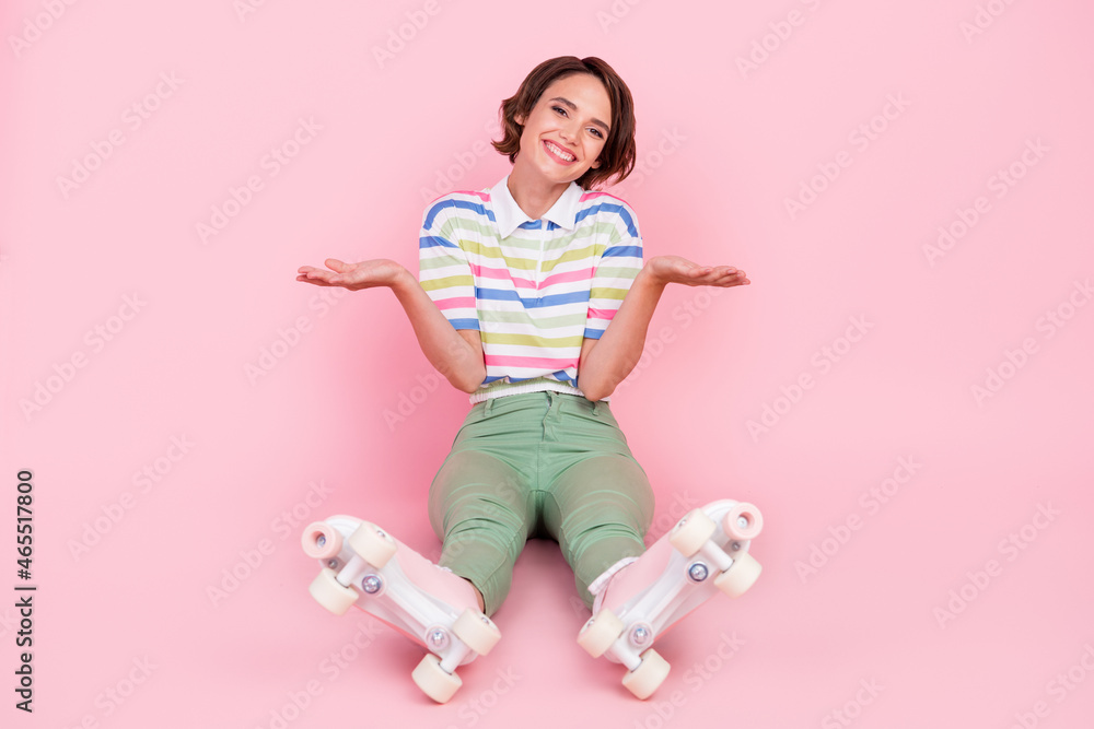 Full length photo of young girl happy positive smile shrug shoulders roller skater isolated over pastel color background Full length photo of young girl happy positive smile shrug shoulders roller skater isolated over pastel color background