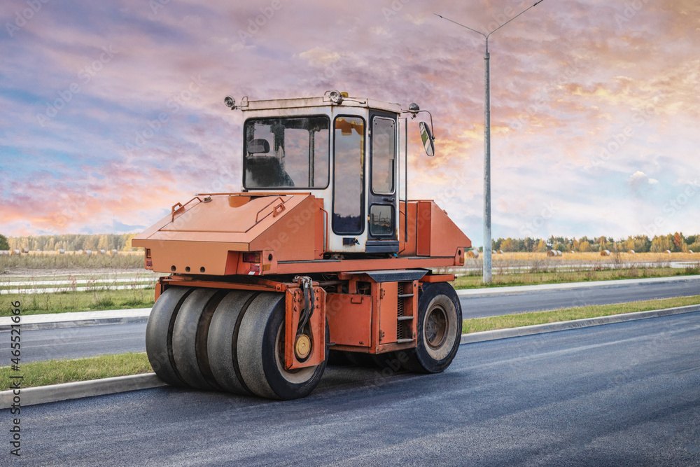 Obraz premium Heavy-duty vibratory roller for asphalt paving. Road construction. Construction of roads and urban transport communications. Heavy machinery.