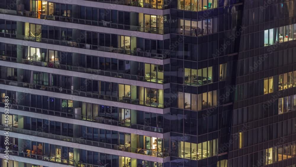 Windows lights in modern office and residential buildings timelapse at night