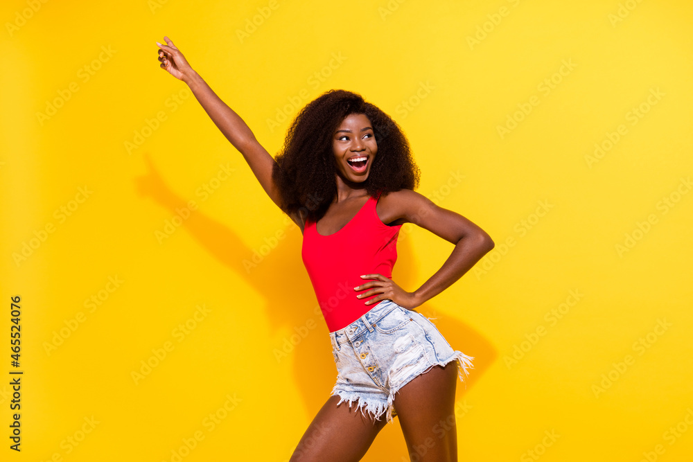 Naklejka premium Portrait of attractive cheerful girl having fun rest dancing free time weekend isolated over bright yellow color background