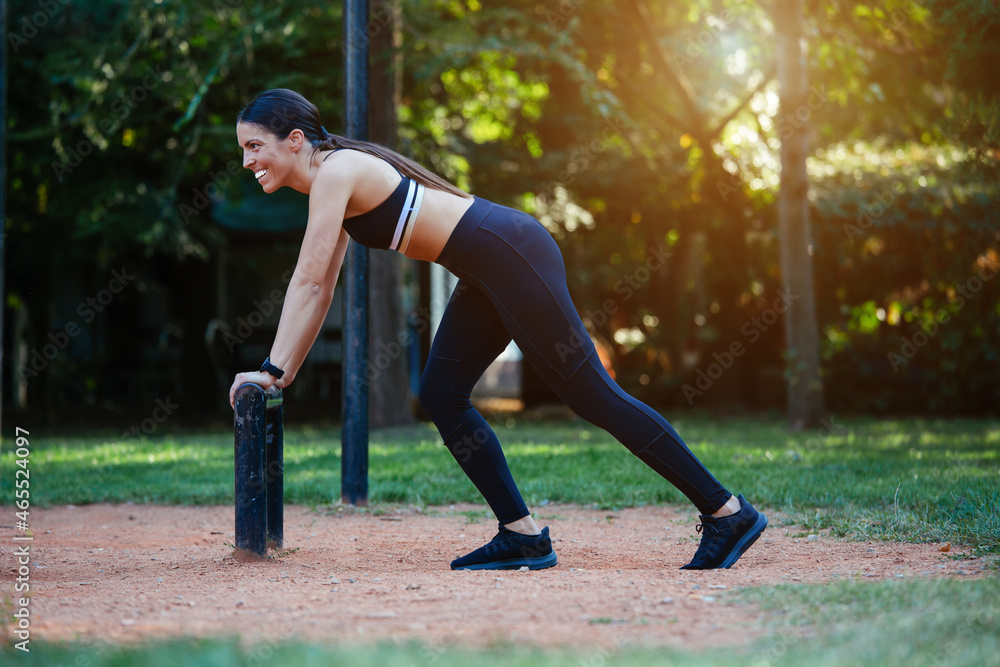 Fototapeta premium Young sporty female relaxing after physical exercise outdoors during free time