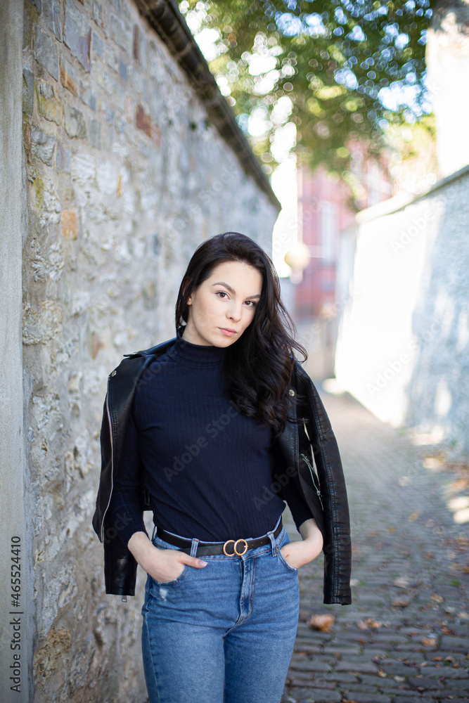 White young girl with dark hair with wall behind White young girl with dark hair with wall behind