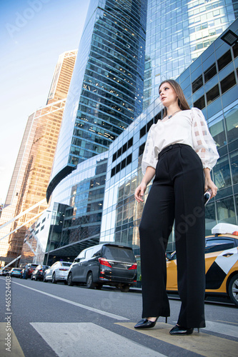 Wallpaper Mural Concentrated young business woman in modern city of skyscapers at the pedestrian crossing Torontodigital.ca