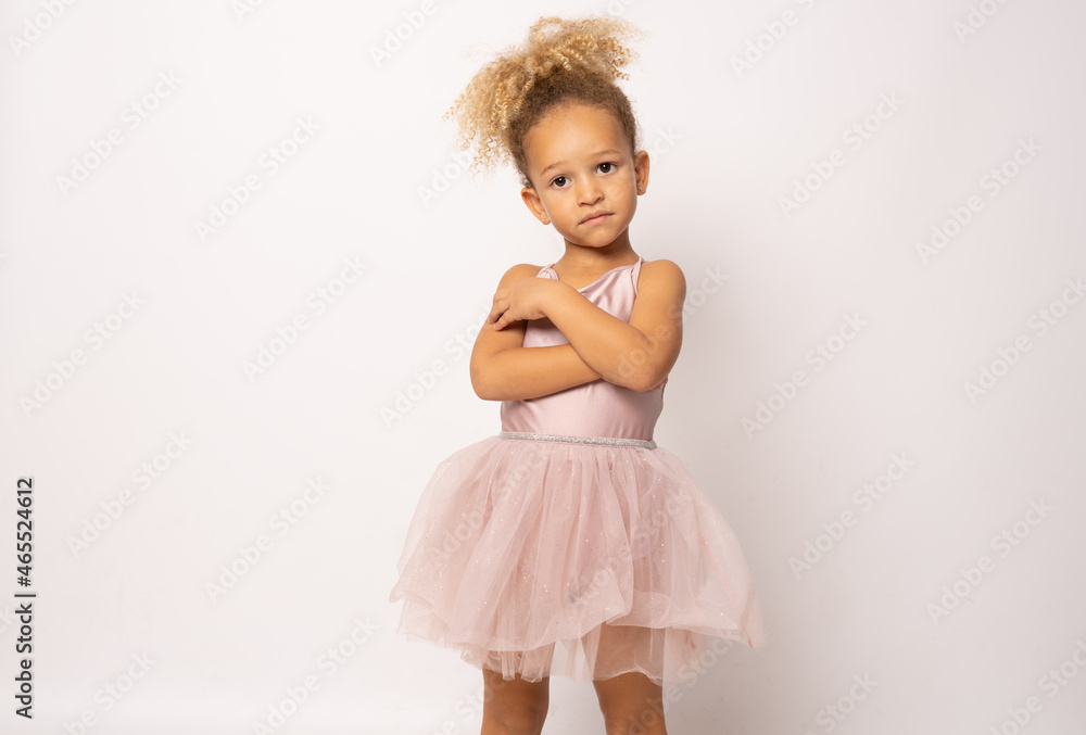 The little ballerina getting ready for class isolated over white background. The little ballerina getting ready for class isolated over white background.
