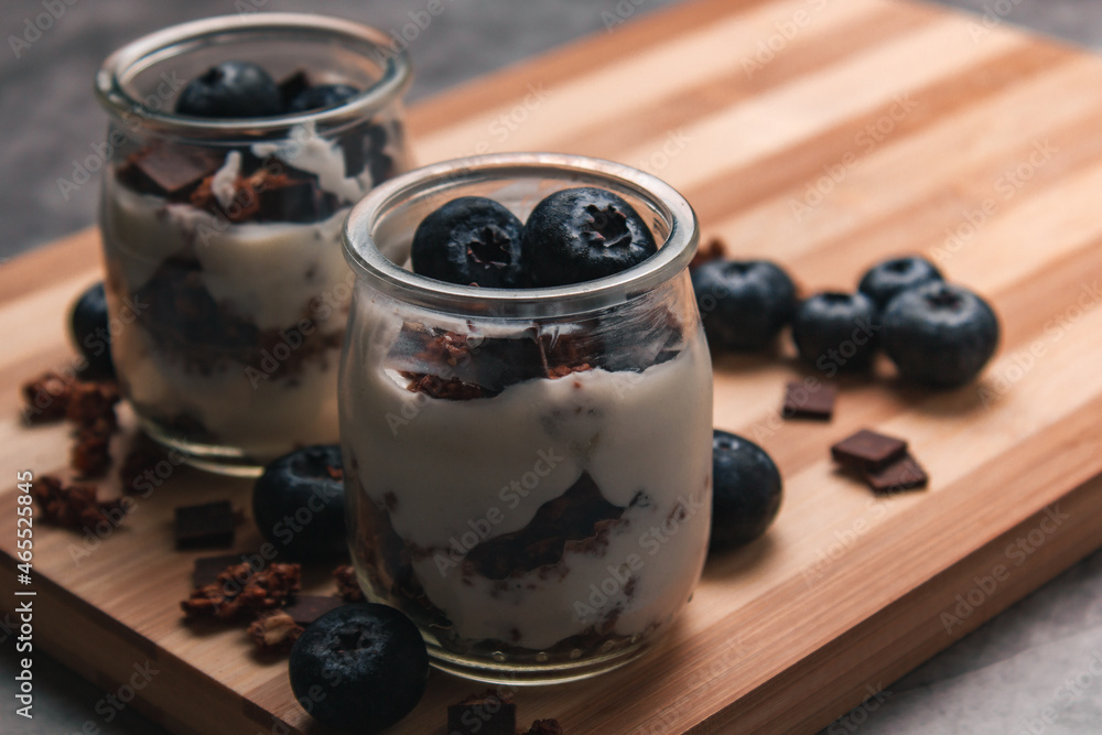 Healthy breakfast: yogurt with berries and muesli in jars. Selective focus. Healthy breakfast: yogurt with berries and muesli in jars. Selective focus.