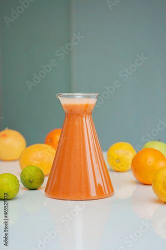 Juicing vegetables and fruits! Bright and colorful fruit drink, oranges, grapes, apples, lemons and limes on a background. photo