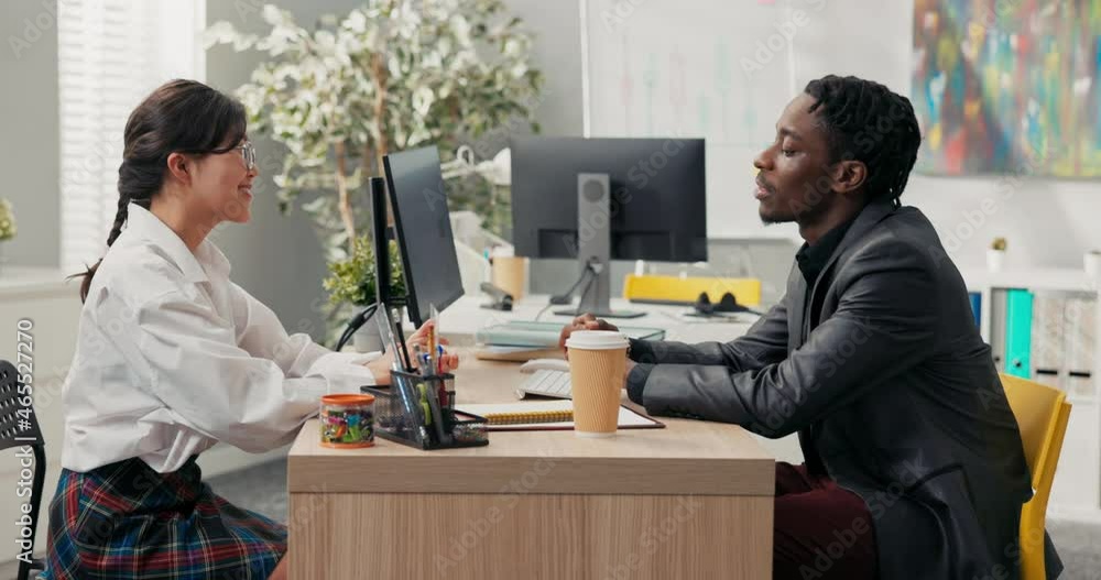 head of company, dark-skinned in suit, talks to candidate for position ...