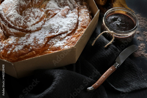 Ensaimada, a pastry typical of Mallorca, Spain, on a dark background