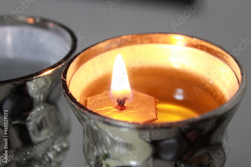 burning candle in a glass