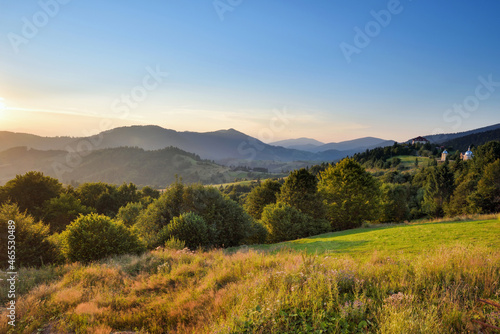 Fototapeta Naklejka Na Ścianę i Meble -  Fantastic sunset and bright grass in sunlight. Carpathian, Ukraine, Europe.