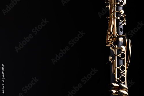 Wall Mural Part of a clarinet with gold plated keys on a black background