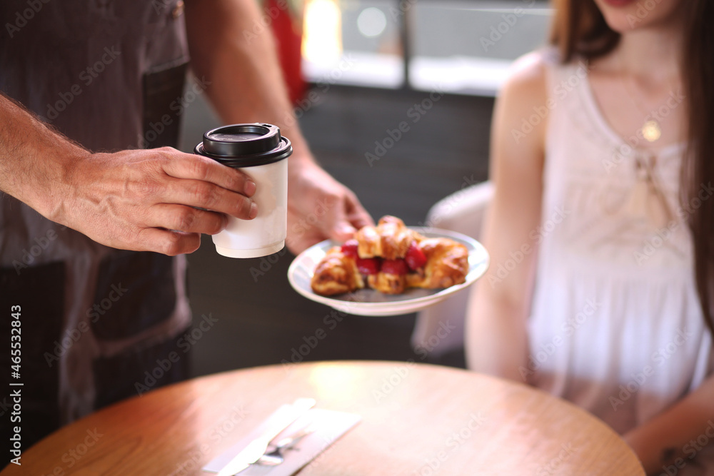 couple eating coffee and donut
