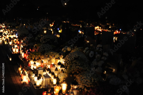 Candle lights on graves and tombstones in cemetery at night in Poland on All Saints    Day or All Souls    Day or Halloween or Zaduszki or Day of the Dead