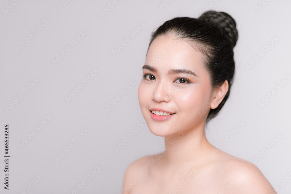 Beautiful young asian woman with clean fresh skin on gray background Beautiful young asian woman with clean fresh skin on gray background