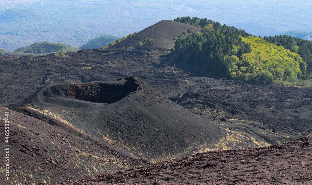 Tourist at the rim of a crater at Etna volcano Sicily