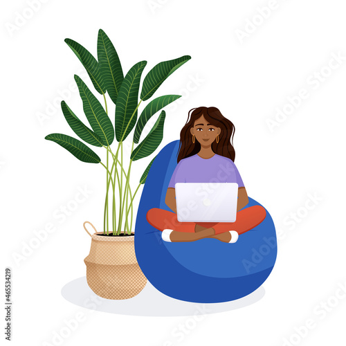 Woman sits on the bean bag chair and works at the computer. Remote work, office at home, programming, freelance. Study at home in quarantine. Vector illustration.