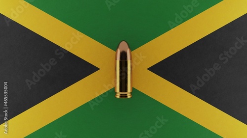 Top down view of a 9mm bullet in the center and on top of the flag of Jamaica