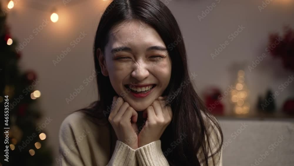 Excited woman looking at camera joyful smiling. happy laughing girl clapping hands while sitting on cozy sofa at home. female talking to lens with surprised emotion on christmas eve indoors Excited woman looking at camera joyful smiling. happy laughing girl clapping hands while sitting on cozy sofa at home. female talking to lens with surprised emotion on christmas eve indoors