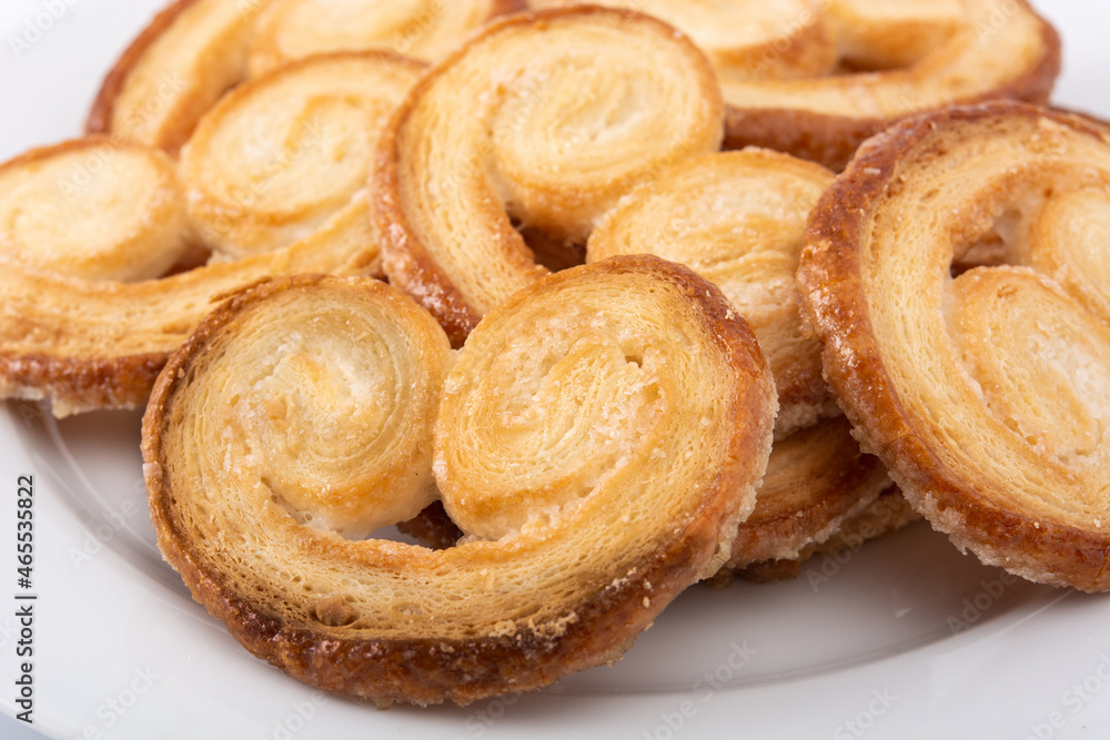 Palmier puff pastry in plate isolated on white background